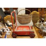 A wicker basket together with a doll's wooden benc