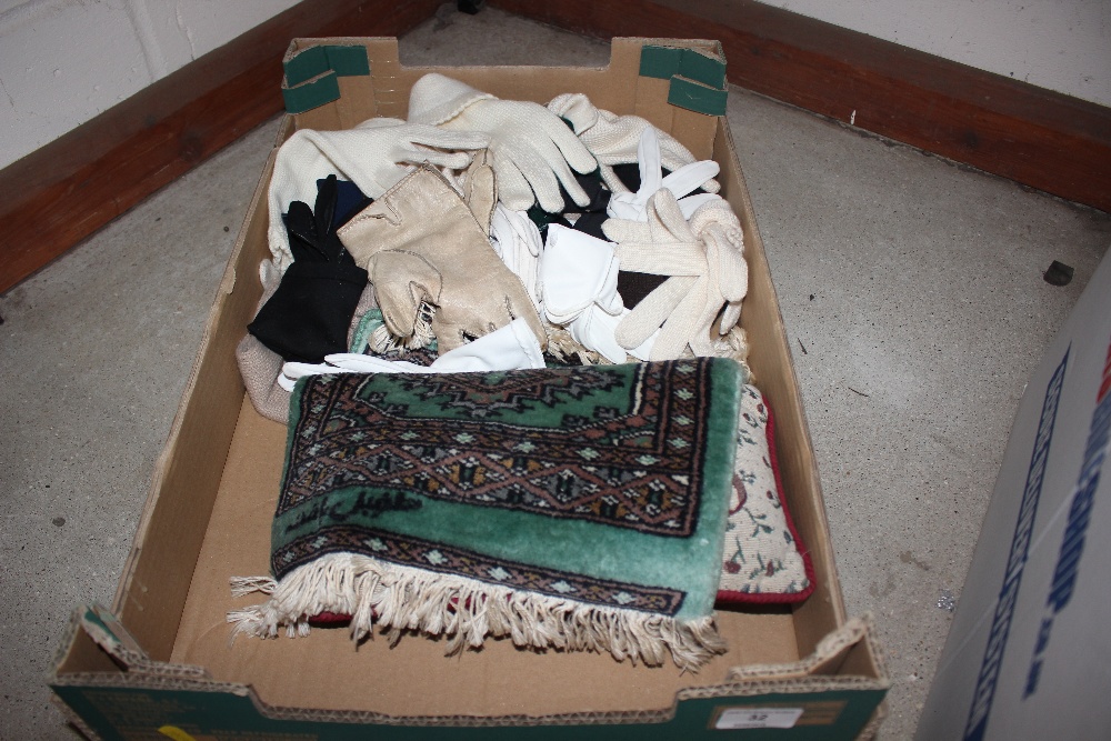 A box containing a small rug; various gloves etc.