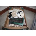 A box containing a small rug; various gloves etc.