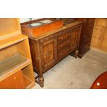 A 20th Century oak three drawer sideboard