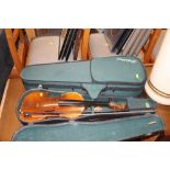 Two cased violins and bows