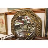 A brass embossed octagonal shaped wall mirror