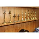 Five pairs of 19th Century and later brass candles