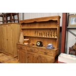 A large stripped pine kitchen dresser fitted three