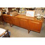 A long teak sideboard fitted three drawers
