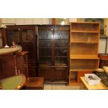 A mid-20th Century oak and glazed bookcase raised