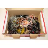 A shoebox of costume necklaces