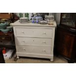 A painted pine three drawer chest