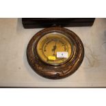 An oak cased and brass barometer