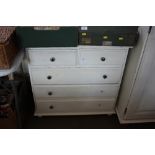 A white painted pine chest fitted two short over t