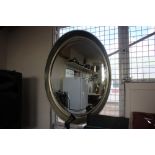 A large oval bevel edged wall mirror