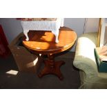 A reproduction mahogany circular topped table