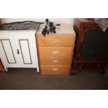 A bedside chest fitted four drawers