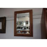 A pine framed bevel edged wall mirror