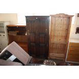 An oak linen fold decorated two door wardrobe