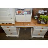 A pine knee hole dressing table fitted six drawers