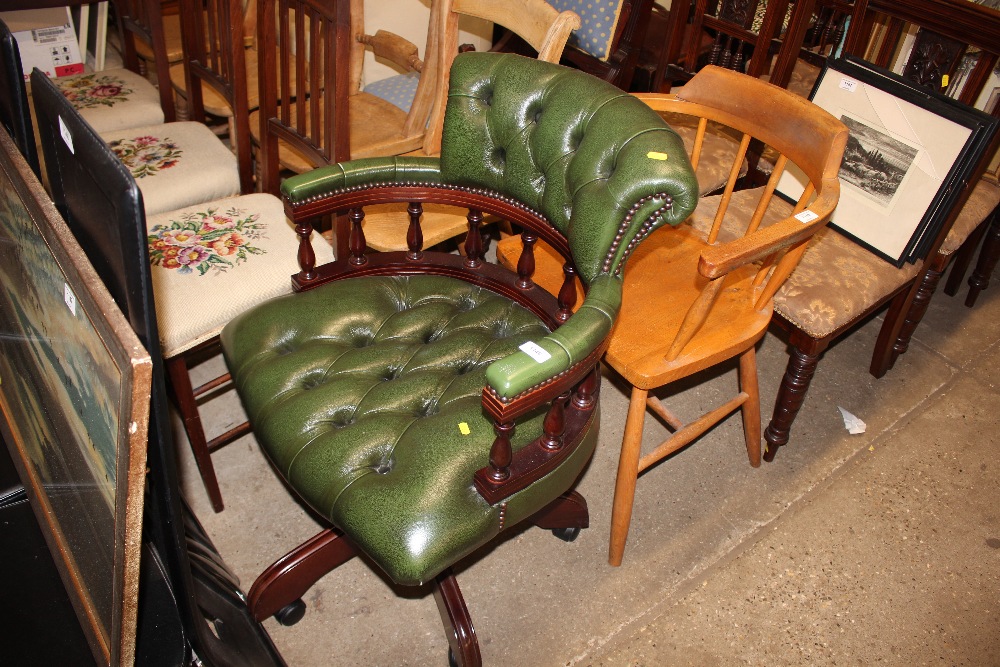 A green leather button down swivel desk chair
