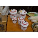 A graduated set of five French enamel storage jars