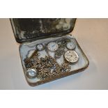 A tin of 19th Century silver and white metal fob w