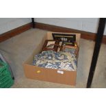 A box of pictures, frames and a floral bedspread