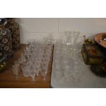 A quantity of various cut and etched glass drinkin