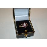 A 9ct gold garnet and diamond set ring