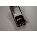 A 9ct gold diamond set cross over ring