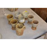 A Bernard Rooke pottery mug, and seven goblets