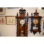 A late Victorian walnut two hole Vienna wall clock