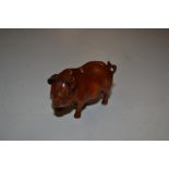 A carved wooden Japanese Netsuke in the form of a pig;