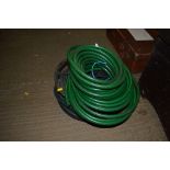 A reel of garden hose and a quantity of hose