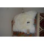 An approx. 2'10" x 1'9" sheep skin wool rug