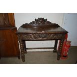 A Victorian oak carved hall table with mask decora