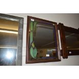 A decorated oblong wall mirror