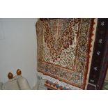 An approx. 5' x 3' floral patterned rug