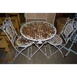 An ornate metal bistro set