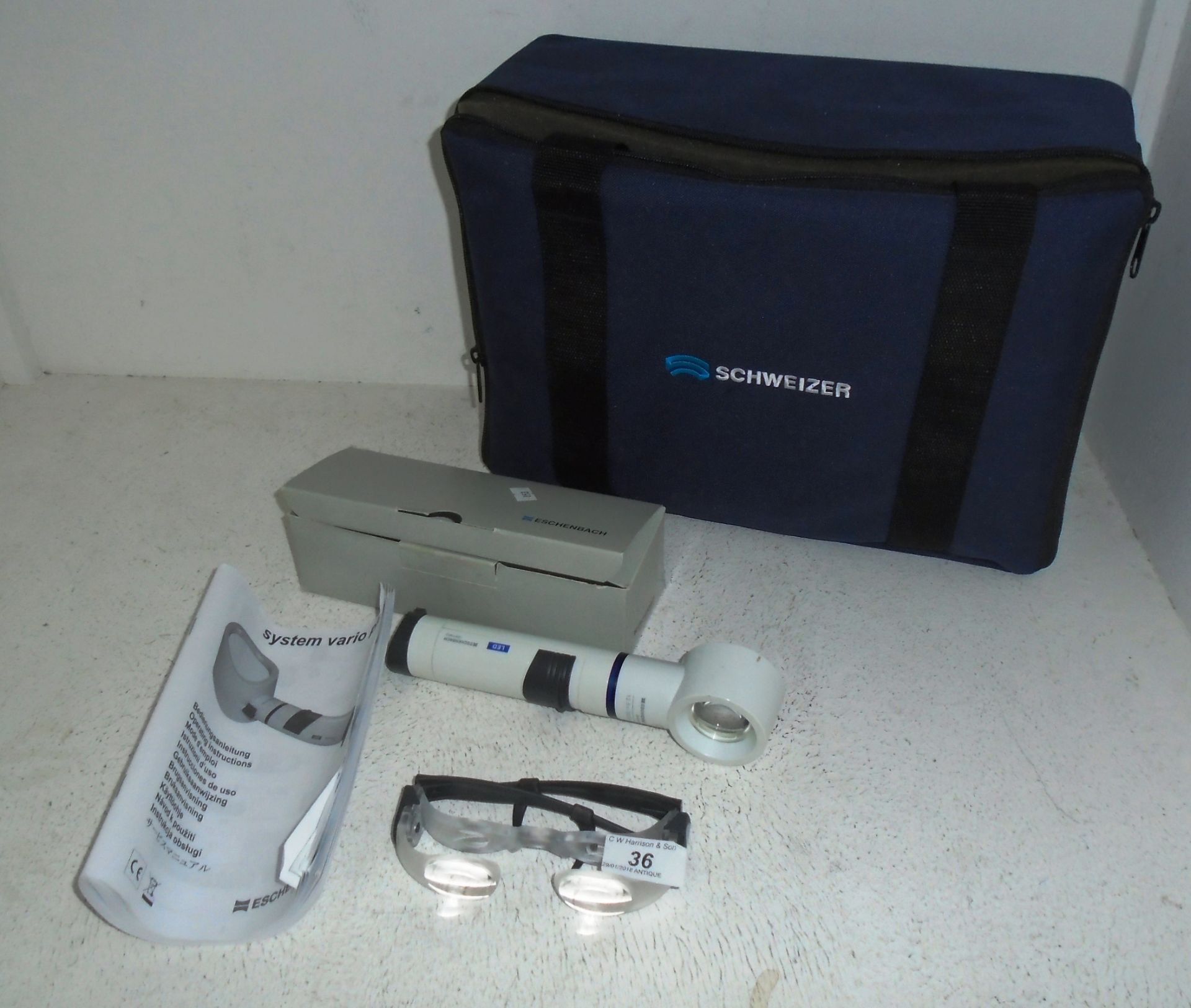 A Eschenbach system Vario Plus magnification unit in case, manual,