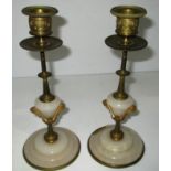 A small pair of brass and onyx candlesticks - 1 base damaged,