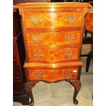 A walnut serpentine front 4 drawer cabinet on cabriole legs