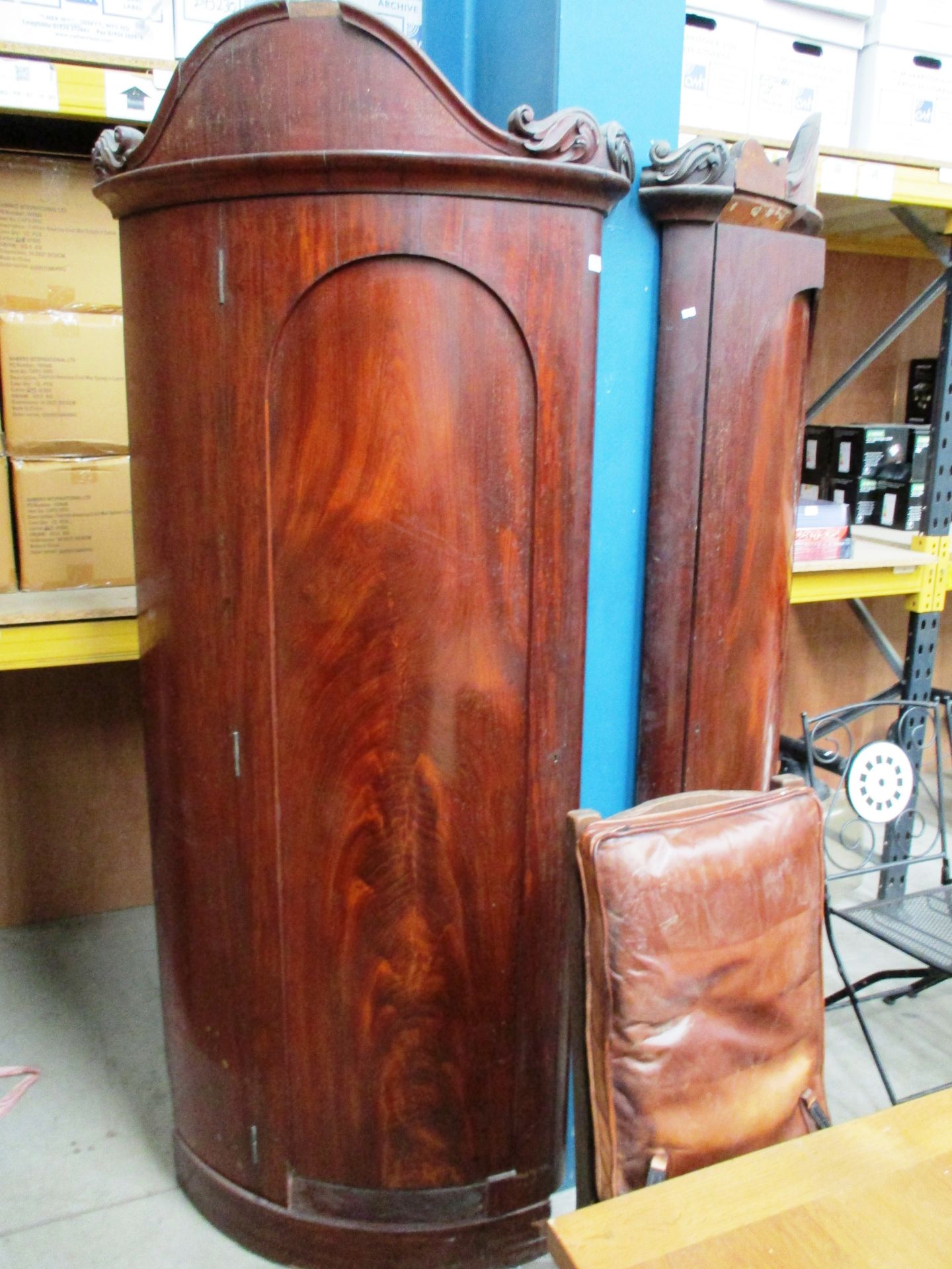 An unusual pair of Victorian curved mahogany corner wardrobes with damages each approx 80cm x 214cm