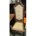 A stained oak high back hall chair with light brown patterned upholstery