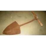A wood handled metal peat spade