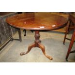 A mahogany circular side table on tripod leg base 90cm dia.