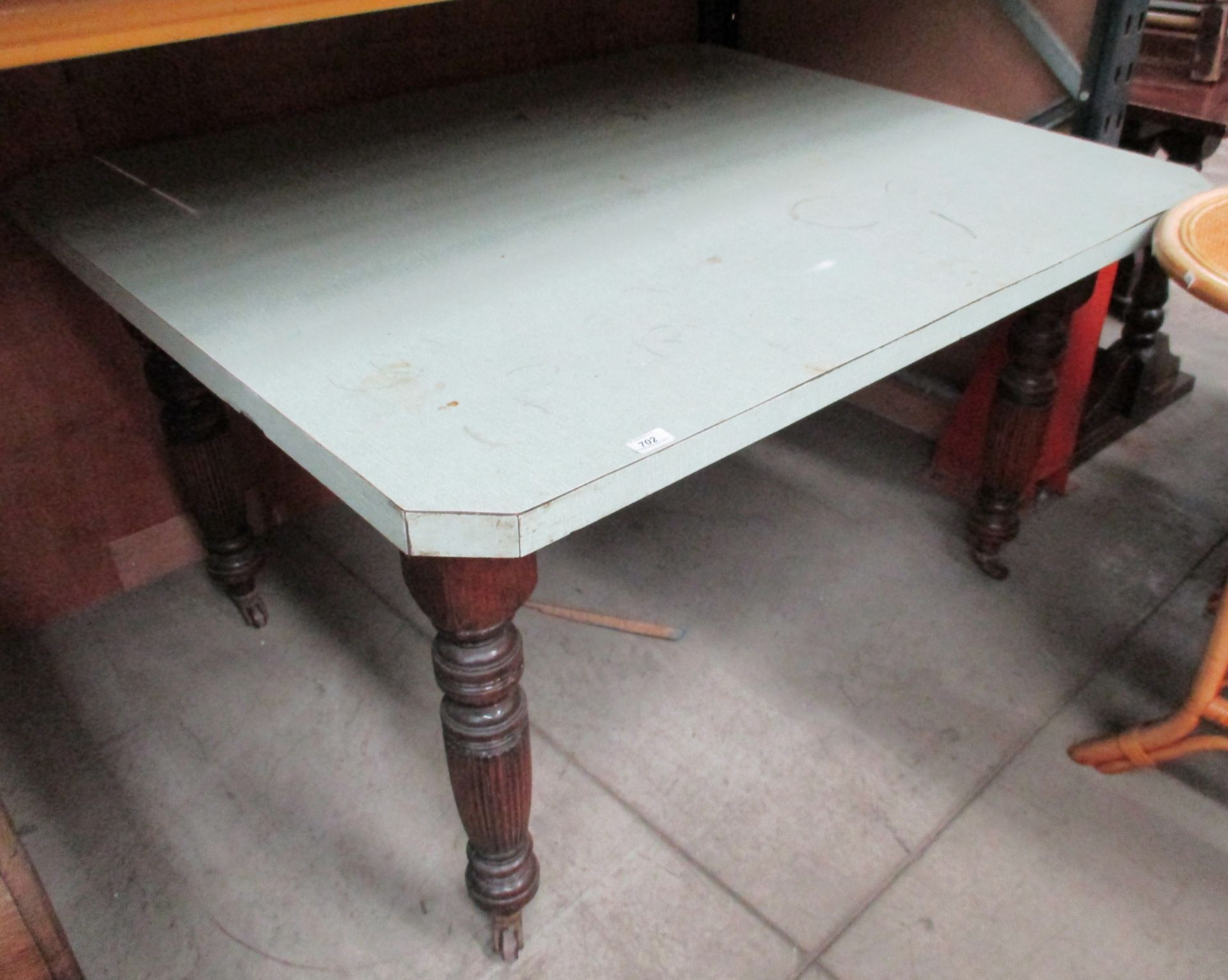A Victorian kitchen table on turned legs with later formica top 110 x 130cm