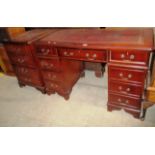 A reproduction mahogany 8 drawer twin pedestal desk with oxblood tooled leatherette top 120 x 60cm