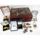 A wooden jewellery box with oriental decoration and a small quantity of costume jewellery