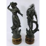 A pair of cast figures on turned wooden bases [as seen]