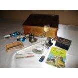 A wooden box with sloping hinged lid, two ring stretching services, ring sizer,