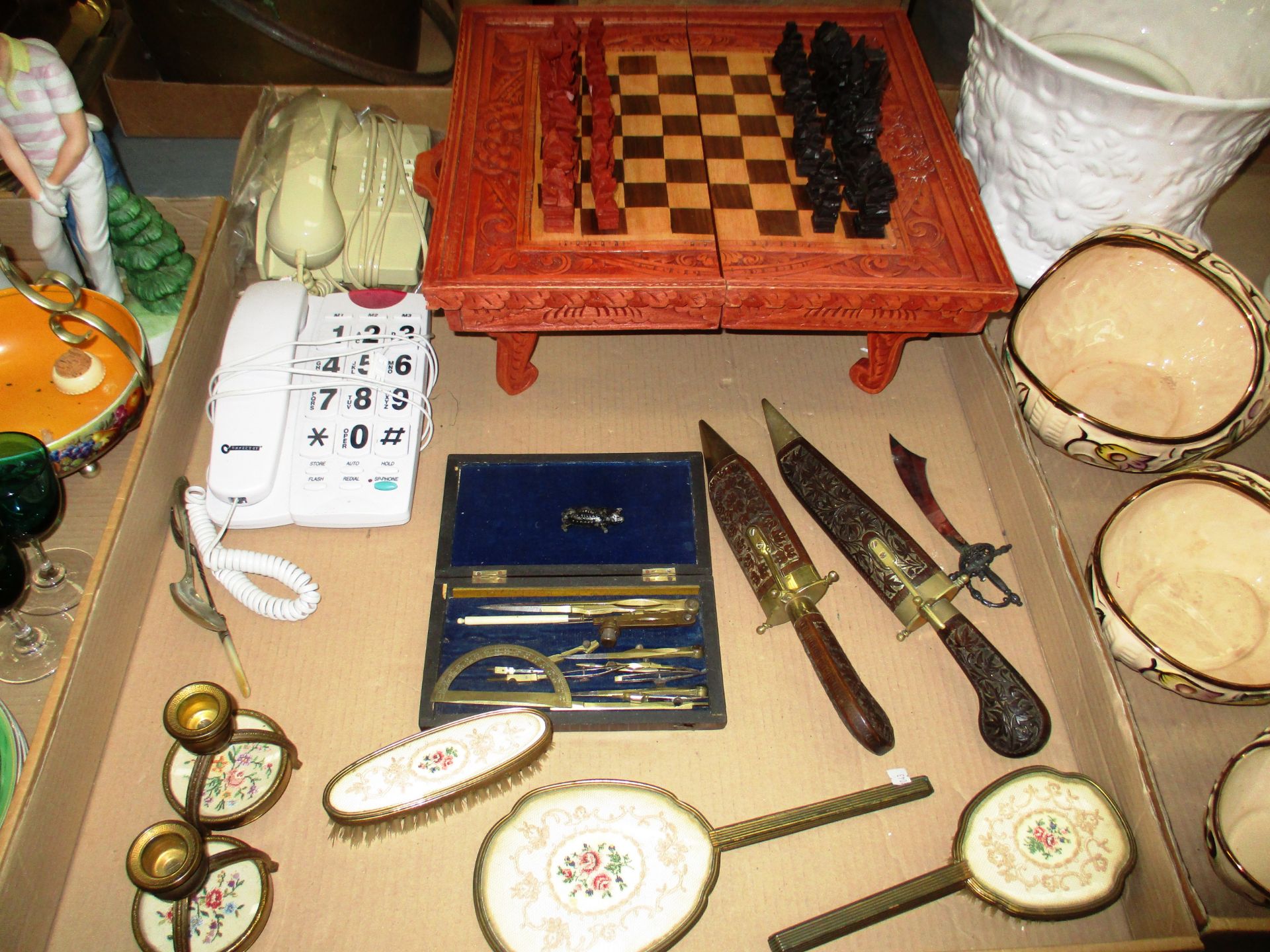 A carved wooden chess set, a brass draughtsman's set in fitted wooden case, repro.