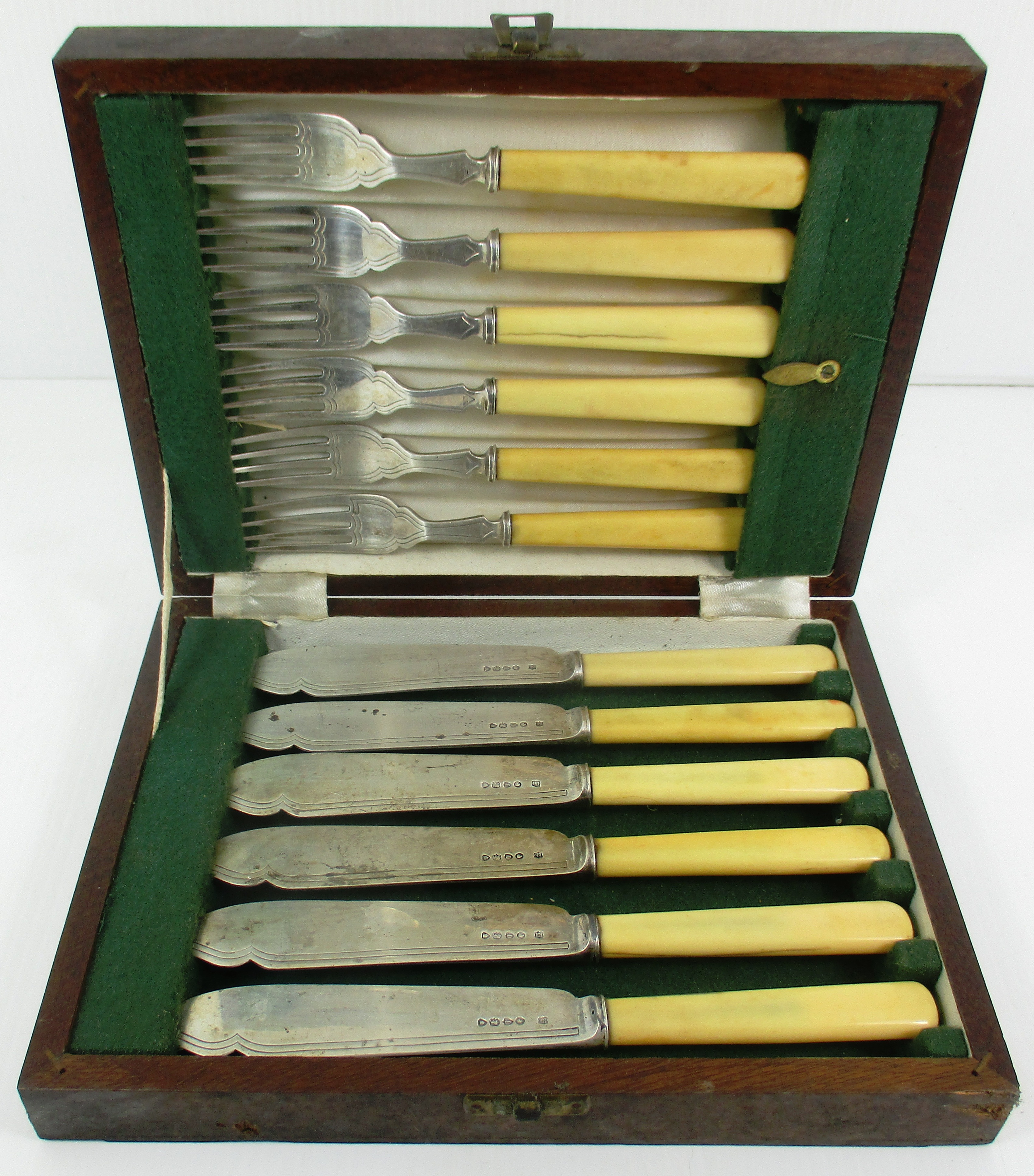 A set of twelve Victorian silver fish knives and forks, each with ivory handle,